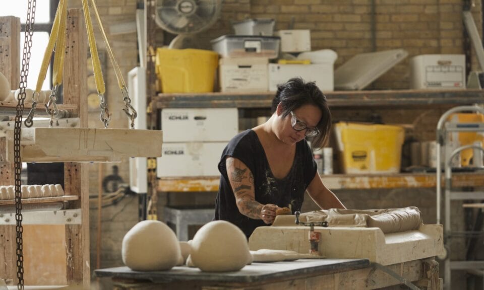 an artist works in a clay studio