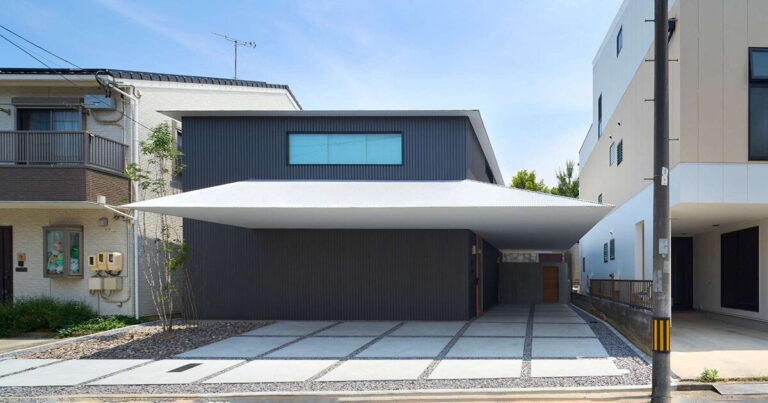 floating white eave slices through black volume of wooden residence by airhouse in japan