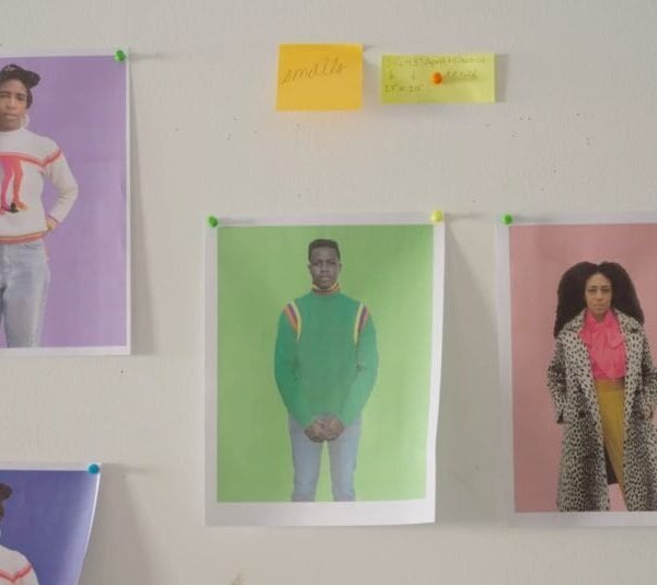 reference portraits and sticky notes on a white wall