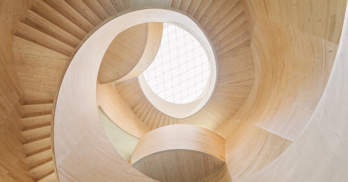 spiraling timber atrium by ICD connects floors at blumer lehmann HQ in switzerland