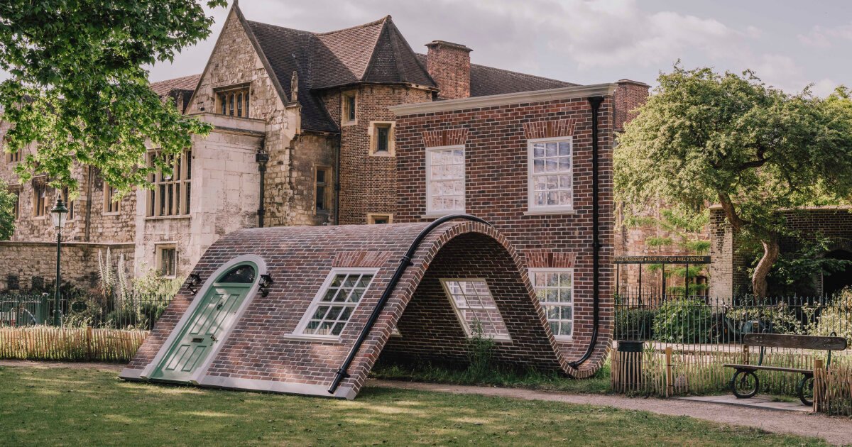 alex chinneck’s brick facade sculpture sits down in london 1 alex chinneck’s brick facade sculpture sits down in london