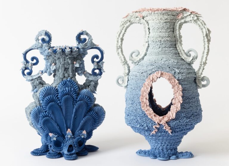 two elaborate, multi-colored ceramic vases made with clay piped like frosting
