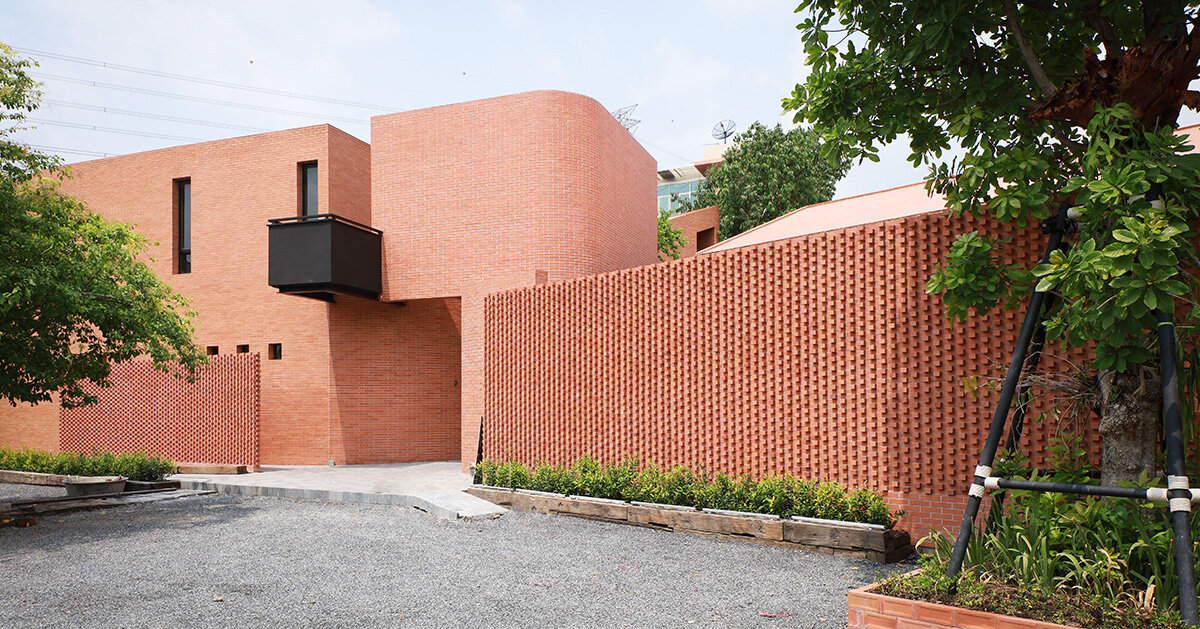 brick wall envelops volume matrix studio's building in bangkok