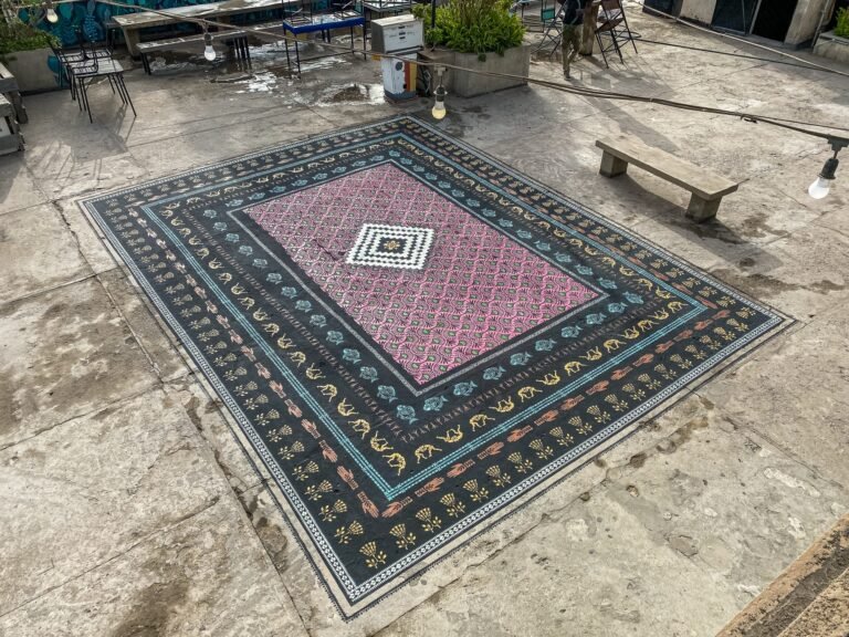 An Ornate Stenciled Rug by Mateo Complements a Cultural Center’s Communal Rooftop in Dakar 11 a spray-painted ornate carpet on a rooftop in Dakar