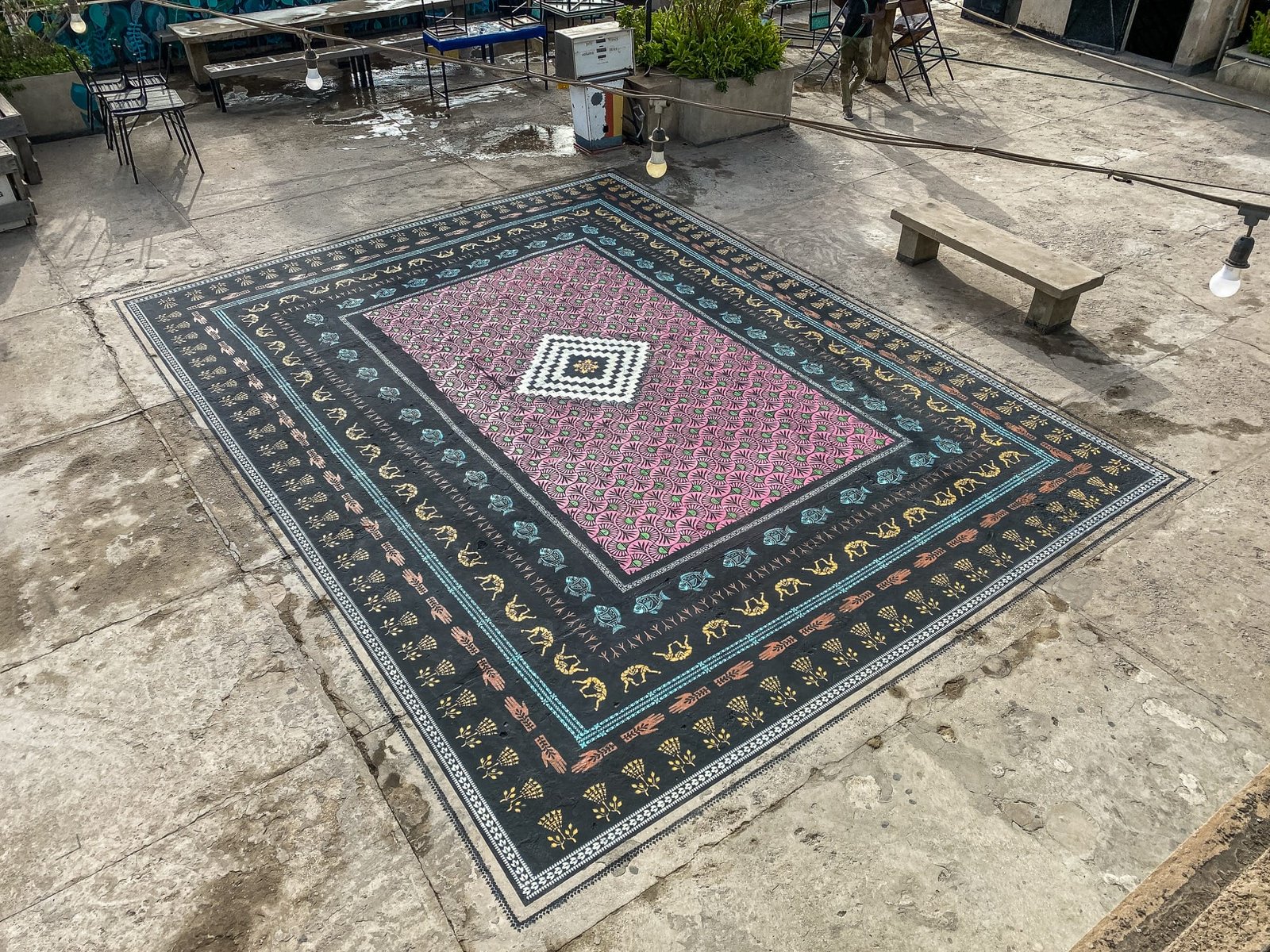 a spray-painted ornate carpet on a rooftop in Dakar