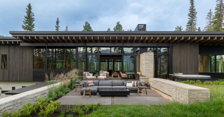 From the outside this home is all blackened wood, but inside it glows with warmth