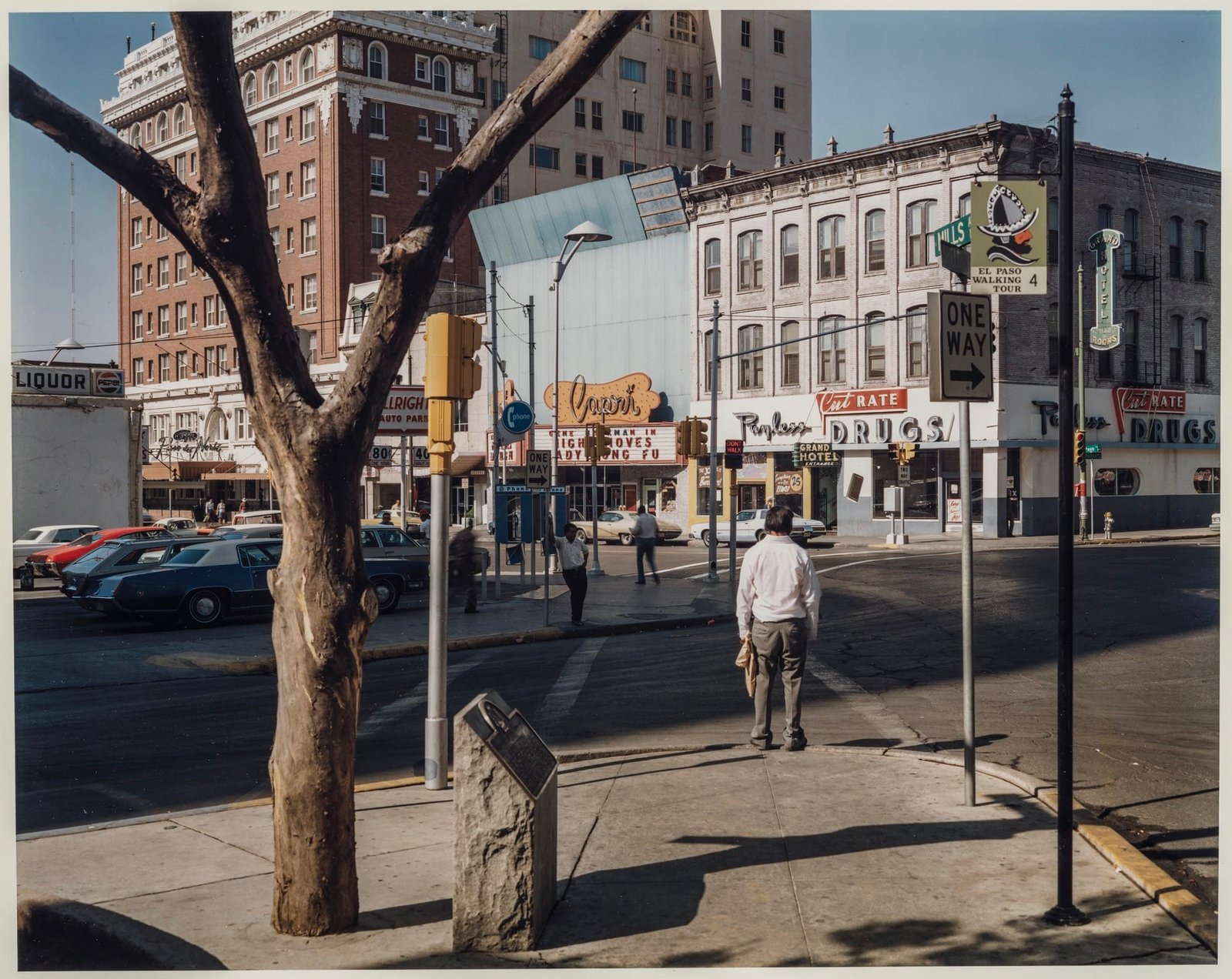 a photo by Stephen Shore of people walking on El Paso Street in El Paso, Texas