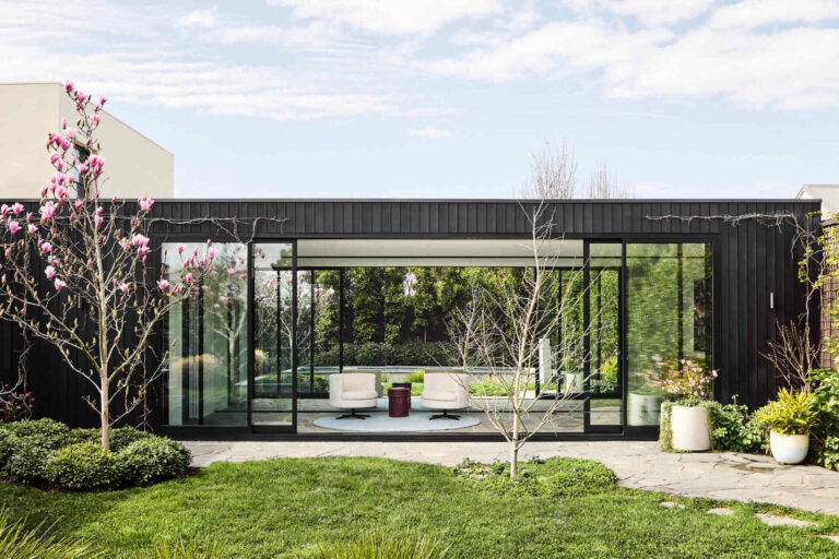 This Melbourne residence combines a restored Victorian facade with dark timber and glass for a seamless modern contrast.