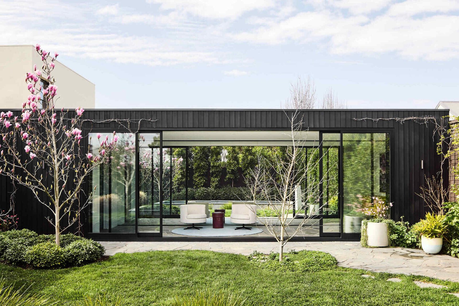 This Modern Extension Reconnects a Victorian House to the Garden 1 This Melbourne residence combines a restored Victorian facade with dark timber and glass for a seamless modern contrast.