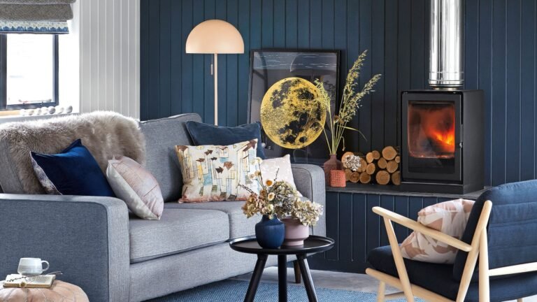 Living room with wood burner in front of blue panelled wall