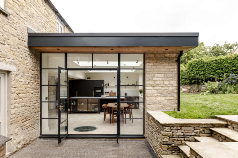 This Charming Stone Cottage Now Features a Light Filled Extension 94 The extension sits at the rear as a low, single storey volume. By sinking it slightly into the garden, its profile stays subtle, reducing its visibility to neighbours and protecting views within the Charlbury Conservation Area. Slim steel framing, large glazing, and Cotswold stone create a gentle dialogue between old and new.