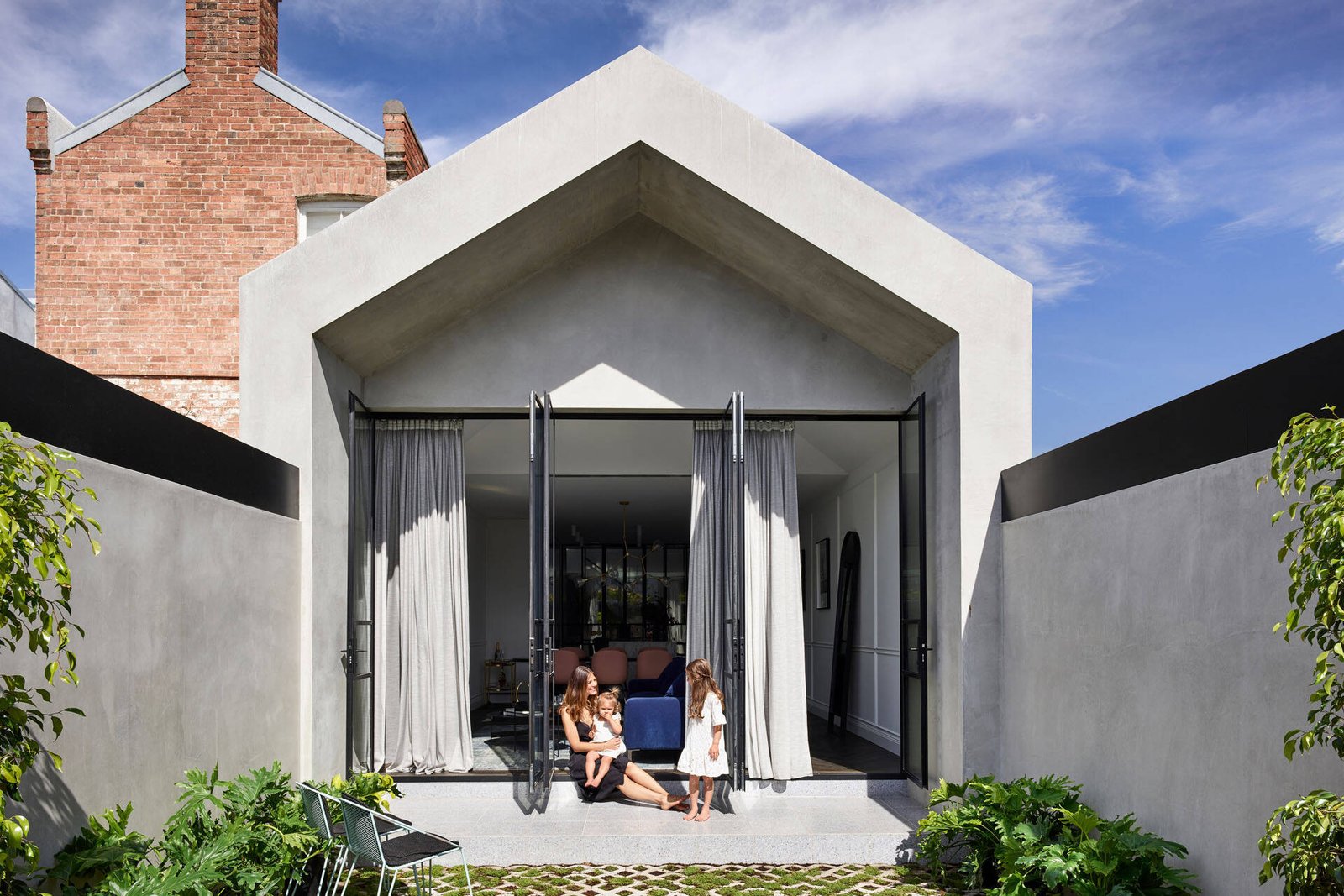 A Victorian-era home is renovated with a modern extension and a hidden indoor garden that brings light, greenery and connection into the centre of family life.