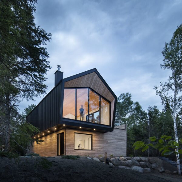 This Quebec home in Charlevoix blends minimalist design with breathtaking St. Lawrence River views for a serene retreat.