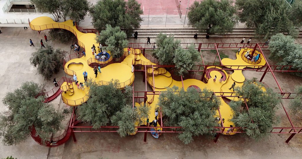 ZAV architects weaves yellow playground through olive orchard in iran