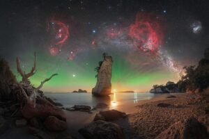 an astronomy photo of nebula over rock formations in New Zealand