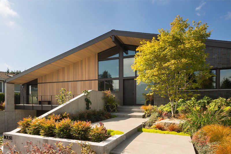A contemporary Bellevue home by Lane Williams Architects combines charcoal grey brick, cedar siding and aluminum windows with landscaping inspired by the home